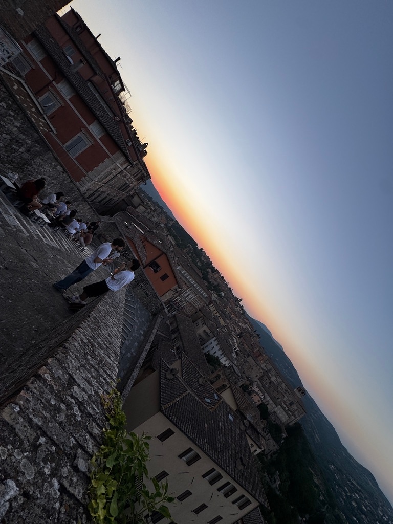 Perugia at sunset from a high stone terrace.