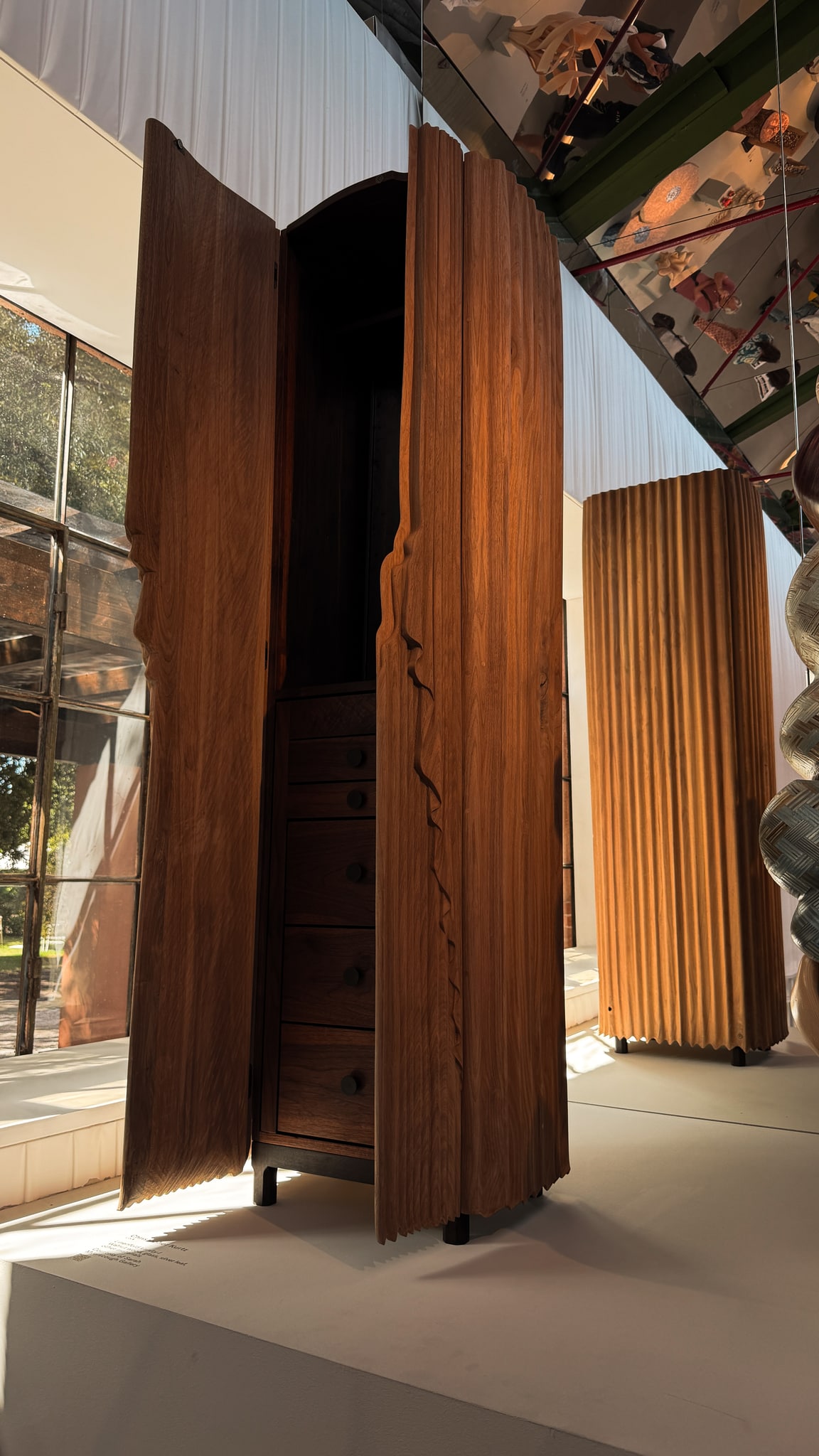 The grain and carved edges of a wooden cabinet.