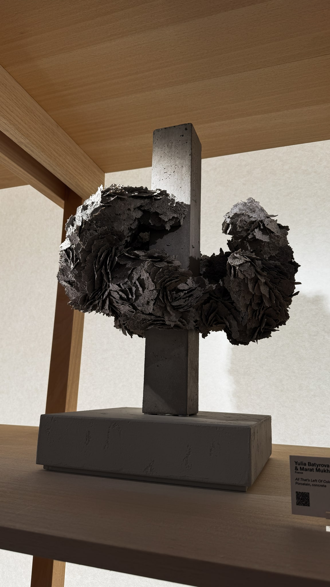 Layered textures around a vertical form.