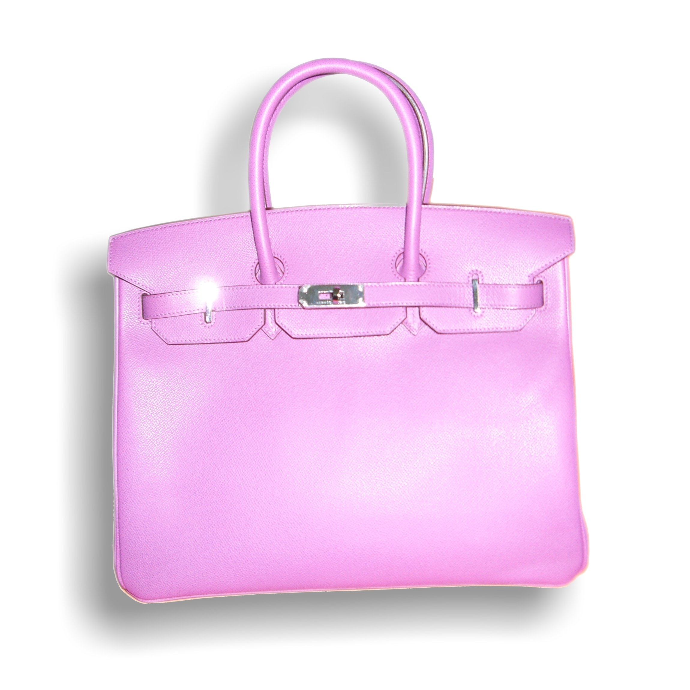 A pink Hermès Birkin bag photographed against a light background.