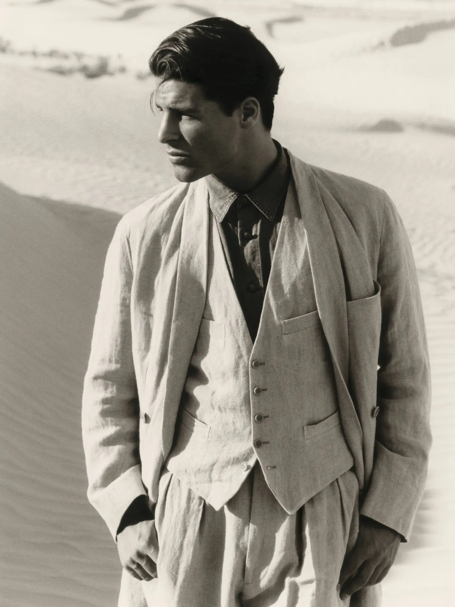 A model in a light Giorgio Armani suit with jacket, waistcoat and trousers, photographed by Aldo Fallai.