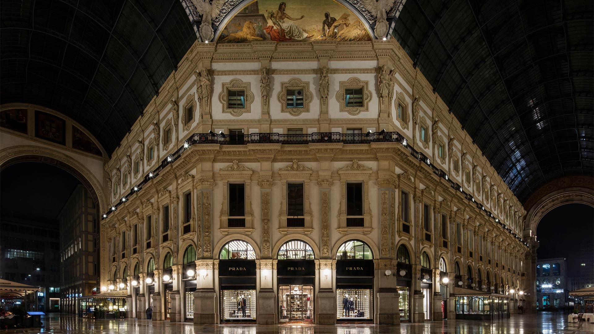 The Prada storefront beneath the illuminated arches of Milan’s Galleria Vittorio Emanuele II.