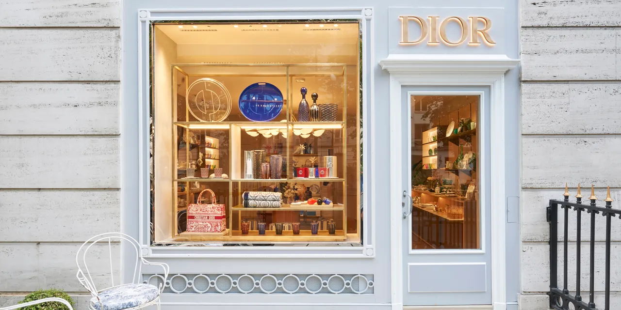 Dior Maison’s pale facade and illuminated display of decorative objects in Paris.