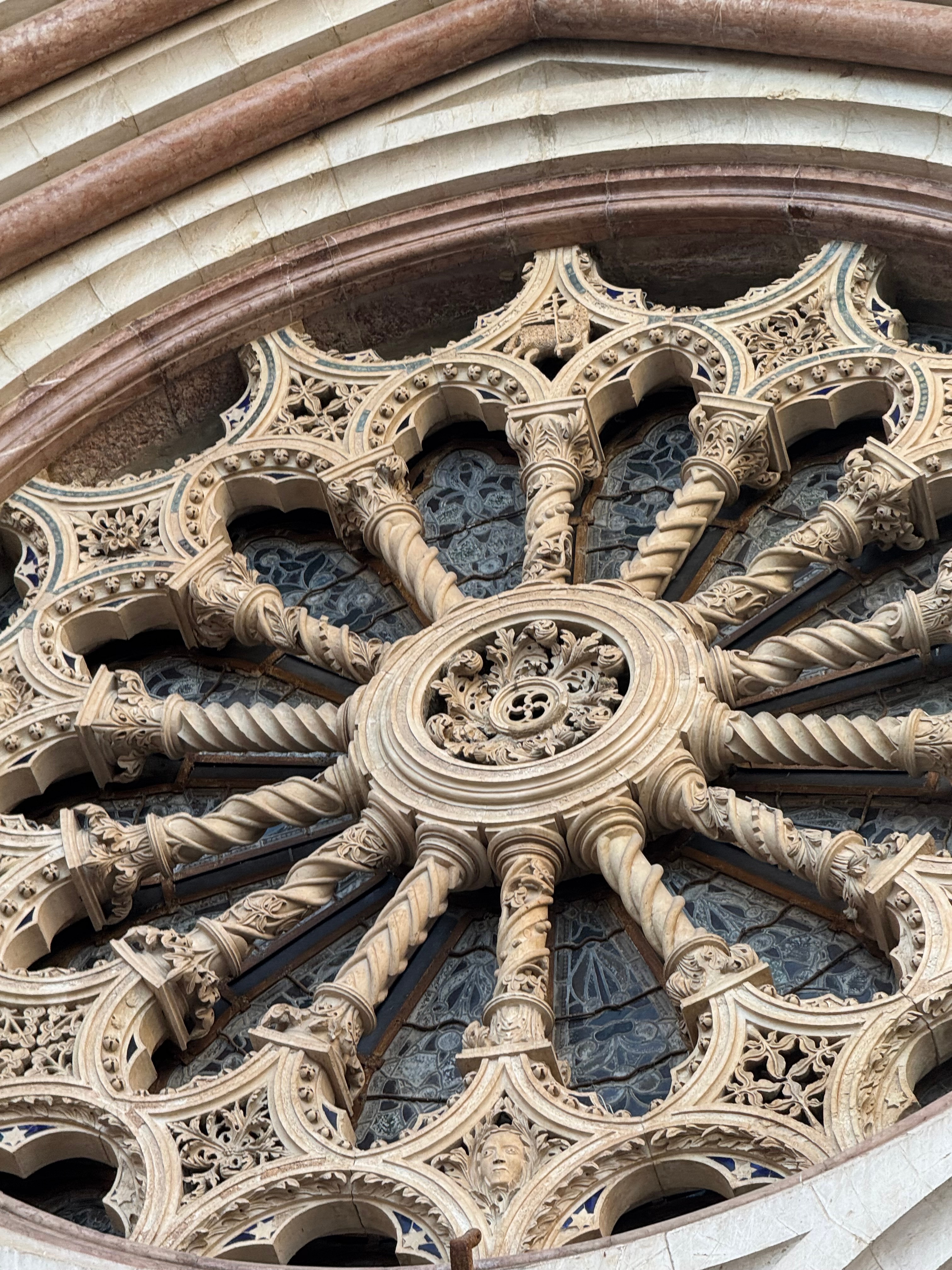 Carved stone rose window on the Basilica of Saint Francis in Assisi.
