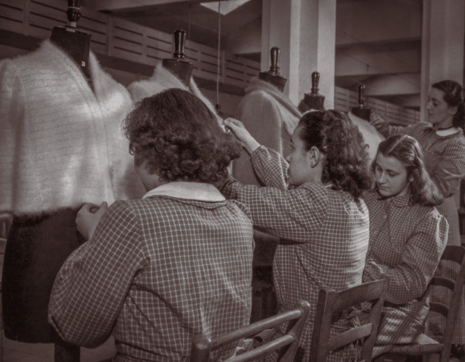 Workers fitting Angora knitwear to dress forms in the Luisa Spagnoli workshop.